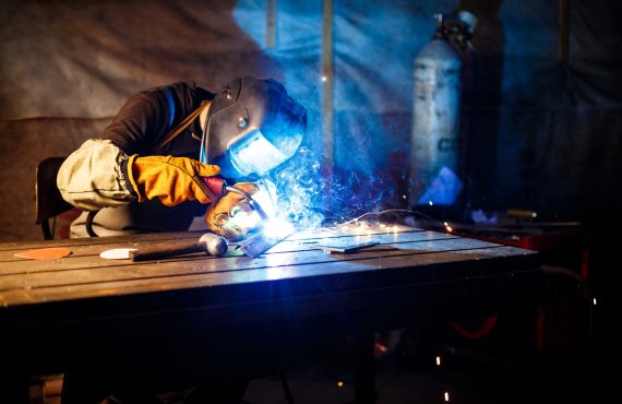 Worker cutting metal with plasma equipment. on plant